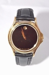 W317- Womens Swiss Movado Museum Folio Black Museum Dial Leather Gold Watch